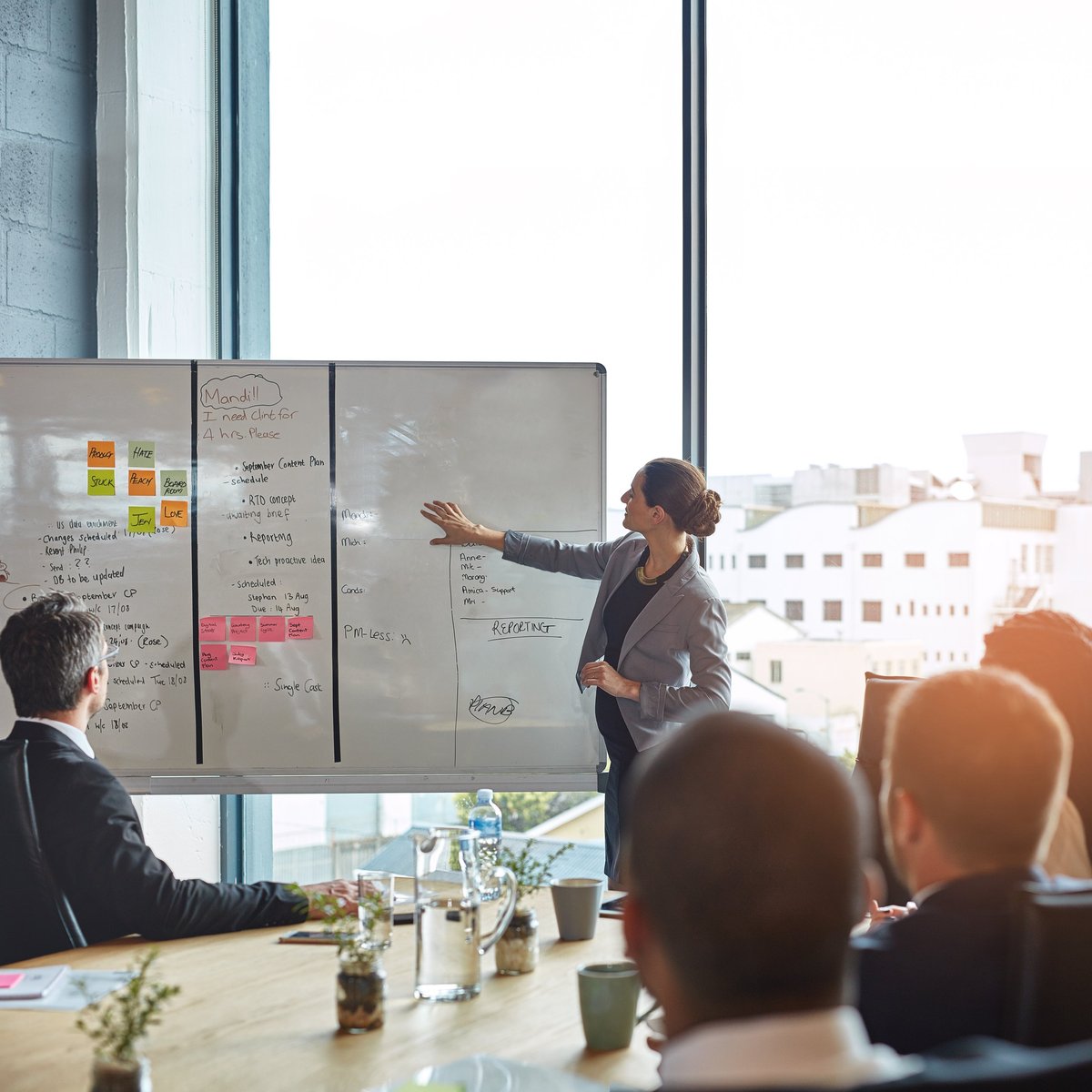 Shot of an executive giving a whiteboard presentation to a group of colleagues in a boardroom